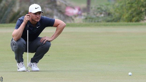 Oliver Fisher lines up a putt