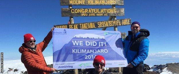 Aaron Phipps at the summit of Mount Kilimanjaro