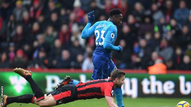 Simon Francis attempts to thwart Danny Welbeck