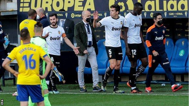 Valencia's Mouctar Diakhaby leaves the field after alleging Juan Cala (r) racially abused him