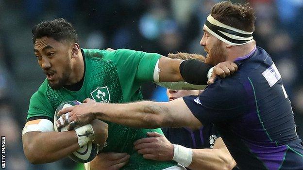 Bundee Aki of Ireland is tackled by Scotland's Simon Berghan