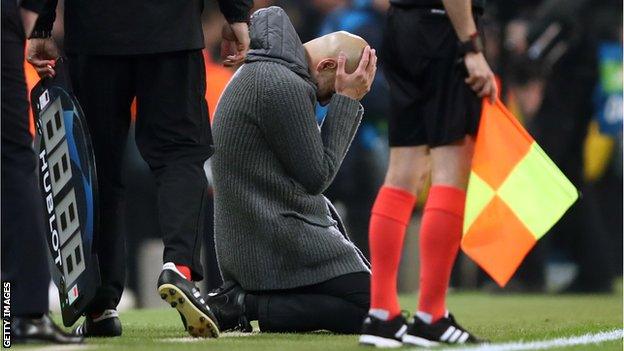 Manchester City manager Pep Guardiola sinks to his knees and puts his head in his hands after Raheem Sterling's late goal against Spurs in the Champions League quarter-final is disallowed