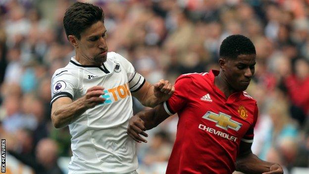 Swansea defender Federico Fernandez challenges Manchester United forward Marcus Rashford