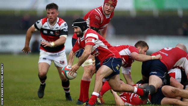 Llanelli scrum-half Gareth George gets the ball away against Pontypool