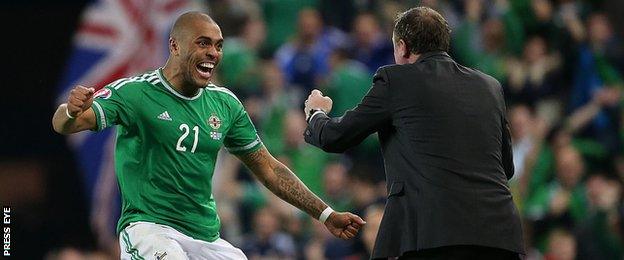 Josh Magennis celebrates with manager Michael O'Neill after scoring his side's second goal in the 3-1 win against Greece