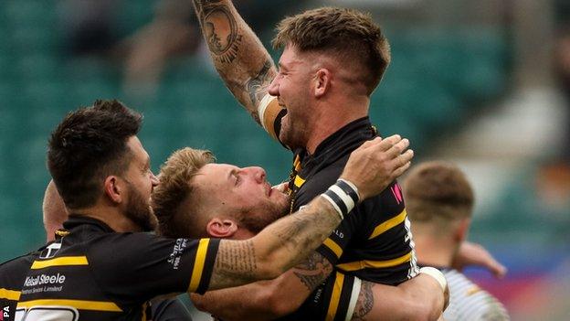 Matt Shepherd is mobbed by his teammates after kicking the winning conversion