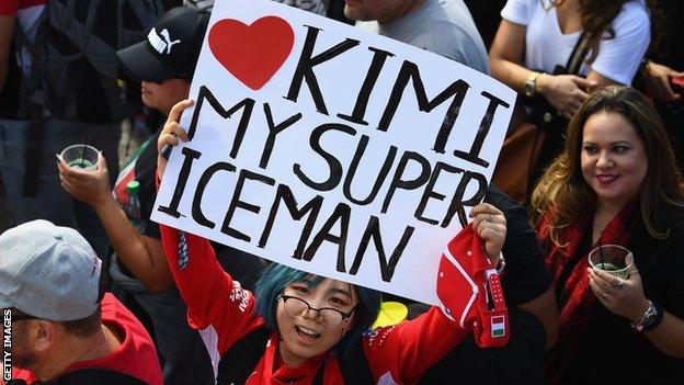 A fan holds up a poster in support of Kimi Raikkonen