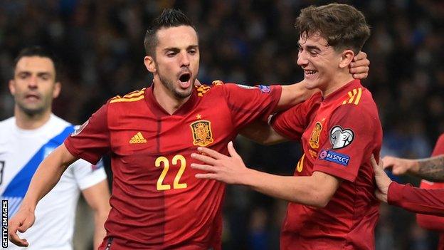 Pablo Sarabia (L) celebrates after scoring a penalty for Spain