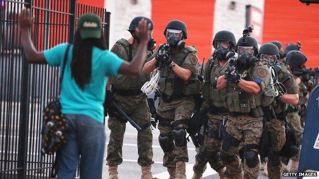 Image contains profanity) Police force protestors from the business district into nearby neighbourhoods on August 11, 2014 in Ferguson, Missouri.