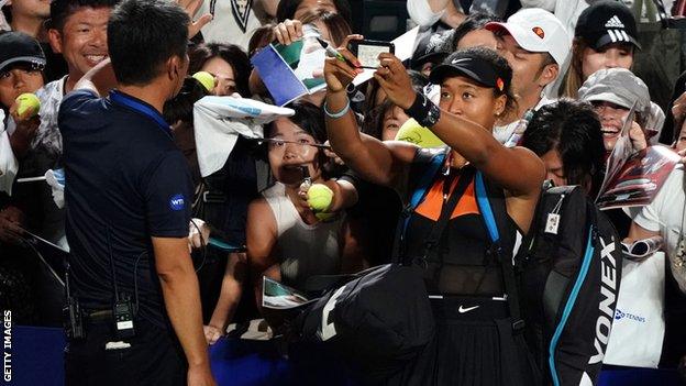 Naomi Osaka takes a selfie with fans