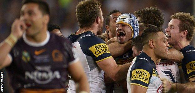 Johnathan Thurston of the Cowboys celebrates with team mates after kicking the winning field goal during the 2015 NRL Grand Final