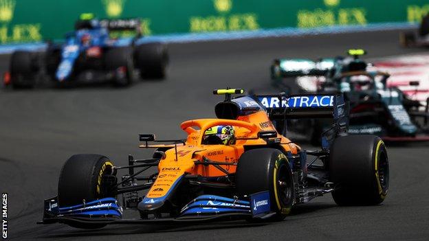 Lando Norris passes the Aston Martin and Alpine at the French Grand Prix