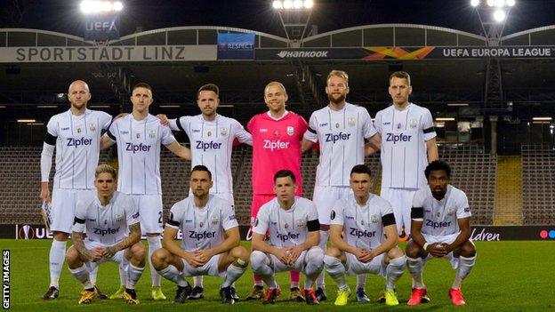 LASK players line up before their match against Manchester United