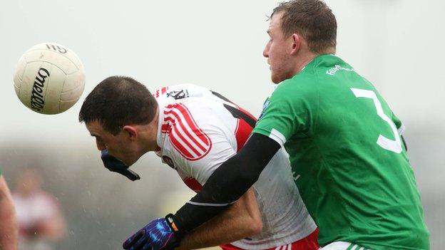 Derry full-forward Cailean O'Boyle is challenged by Fermanagh's Aidan Breen