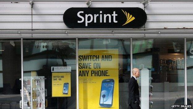 A pedestrian walks by a Sprint store