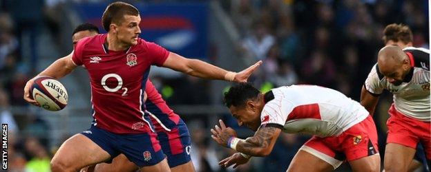 Henry Slade hands off a Tonga defender