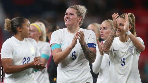 Millie Bright celebrates with England teammates