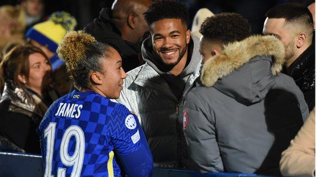 Lauren James heads over to speak to her brother after he debut for Chelsea