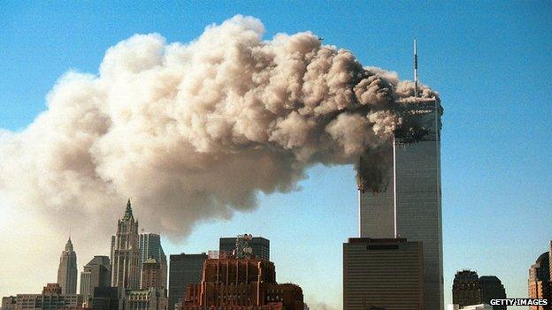 Smoke pours from the World Trade Center after it was hit by two hijacked passenger planes on 11 September 11.