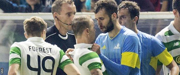 Astana's Igor Shitov confront Celtic striker Leigh Griffiths