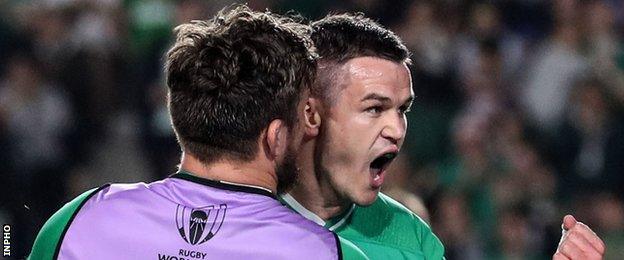 Johnny Sexton celebrates with Ireland replacement Andrew Porter