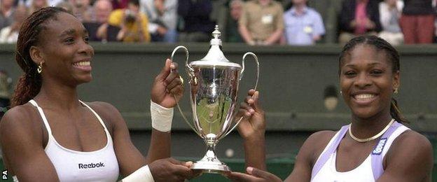 Venus and Serena Williams celebrate their Wimbledon doubles title together in 2000