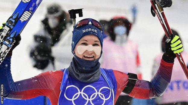 Marte Olsbu Roeiseland celebrates winning the biathlon women's 10km pursuit