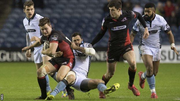 Edinburgh's Chris Dean is tackled by Glasgow's Alex Dunbar