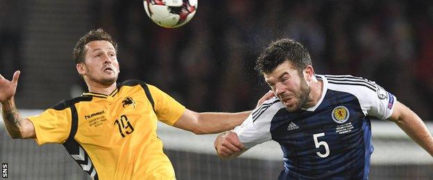 Grant Hanley heads the ball against Lithuania