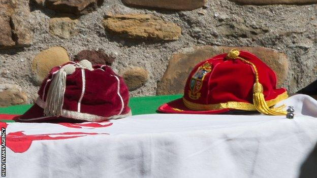 The Welsh flag and Wales and Lions caps adorn John Dawes' coffin