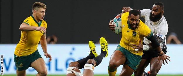 Samu Kerevi of Australia is tackled by Semi Radradra and Tevita Cavubati of Fiji