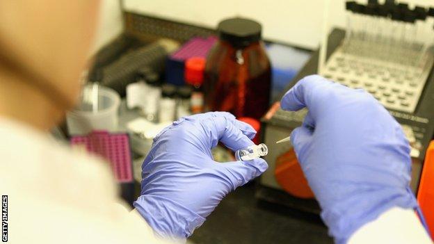 A detailed view of a forensic scientist working with samples