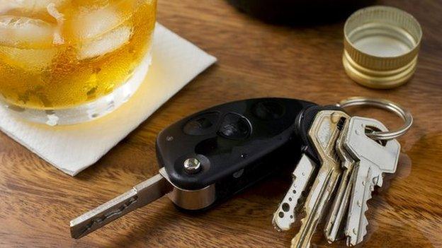 Car keys by a drink