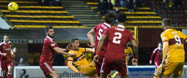 Motherwell's Scott McDonald (third left) watches as his overhead kick hits the net