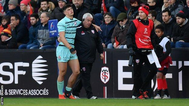 Rees Zammit is helped off the field