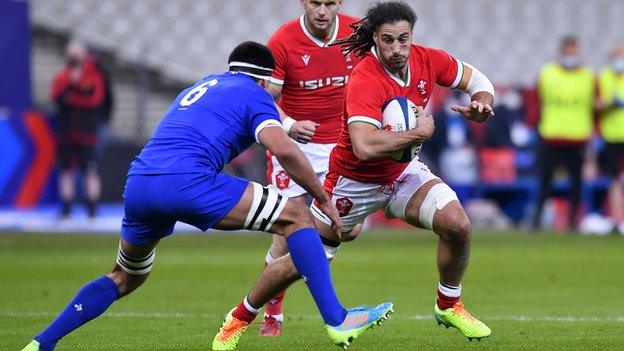 Josh Navidi of Wales is tackled by Dylan Cretin of France