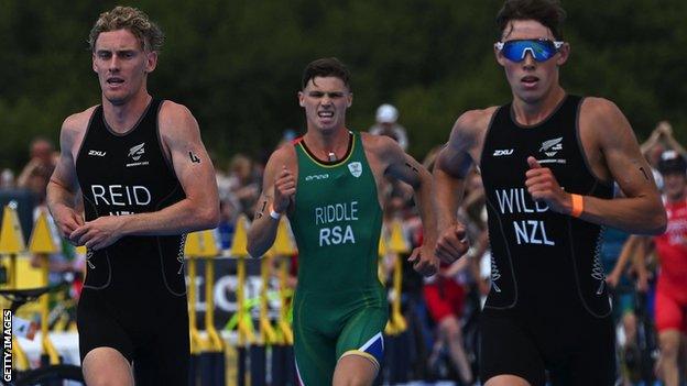 Jamie Riddle of South Africa competes alongside New Zealand's Tayler Reid (left) and Hayden Wilde (right) in action in the men's triathlon at the Commonwealth Games in Brimingham