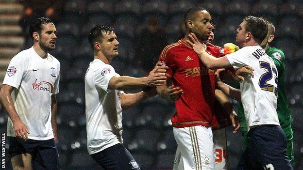 Angry Preston North End players surround Nottingham Forest's Dexter Blackstock
