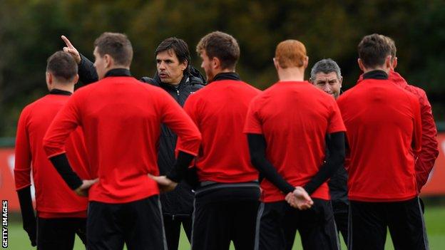 Chris Coleman talks to his players during training