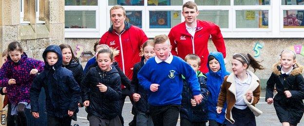 Robbie Renwick and Ross Murdoch with school children in Stirling