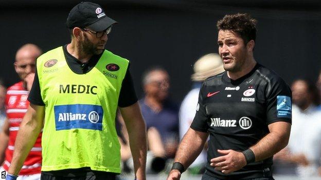 Saracens captain Brad Barritt (right) comes off after suffering an injury against Gloucester