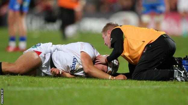 Luke Marshall receives treatment for his injury during the Scarlets game in Belfast