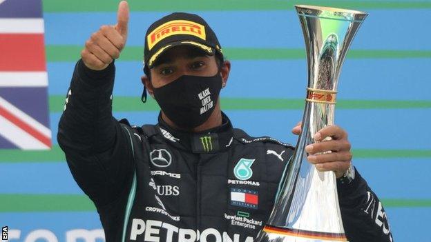 Lewis Hamilton celebrates on the podium