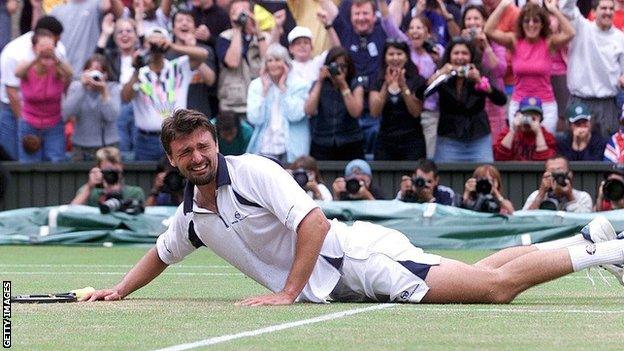 A tearful Goran Ivanisevic falls to the Wimbledon grass in celebration after beating Pat Rafter