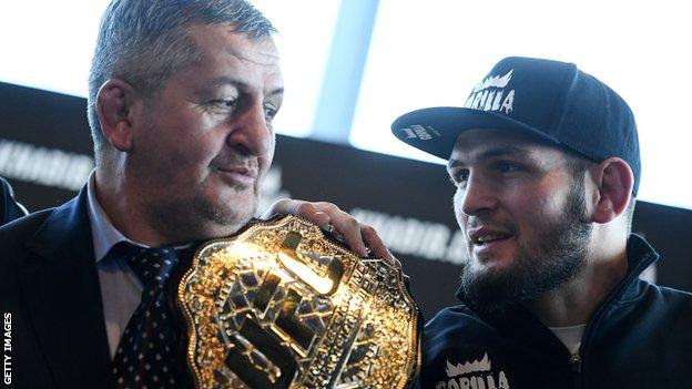 Russian mixed martial artist and UFC lightweight champion Khabib Nurmagomedov (right) with his father and coach Abdulmanap Nurmagomedov at a news conference in 2018