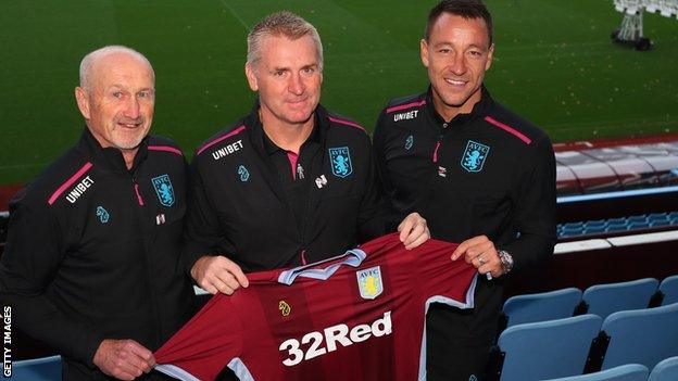 Dean Smith (centre), with assistant coaches John Terry (right) and Richard O'Kelly (left)