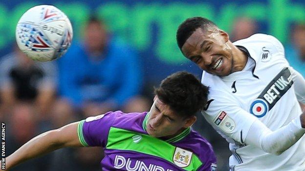 Martin Olsson of Swansea City and Callum O’Dowda of Bristol City compete for the ball