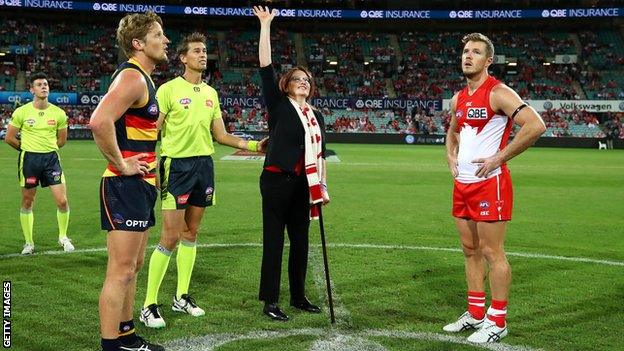 Cynthia Banham tosses the coin on the Sydney Swans pitch