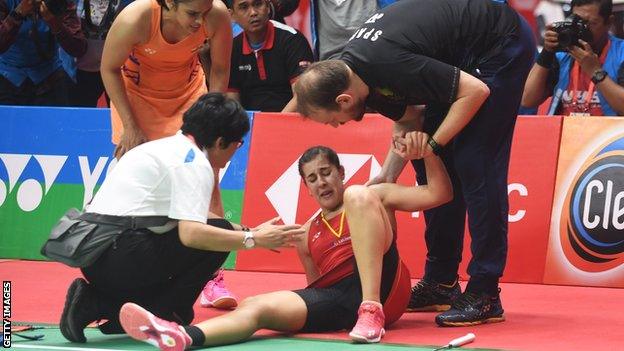 Carolina Marin sits on court in pain