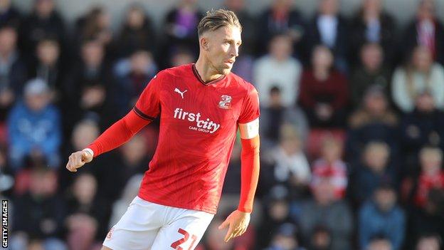 Angus MacDonald playing for Swindon against Northampton